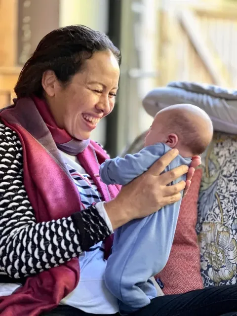 Regina holding a baby